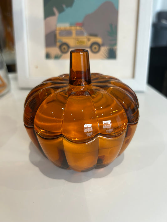Amber glass bottle with a unique design on a white surface